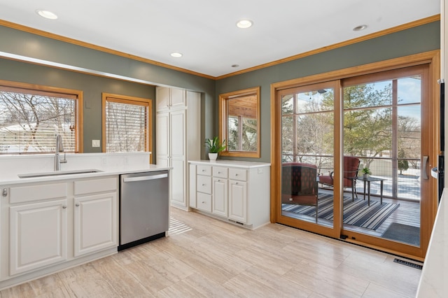 kitchen featuring visible vents, white cabinetry, a sink, light countertops, and dishwasher