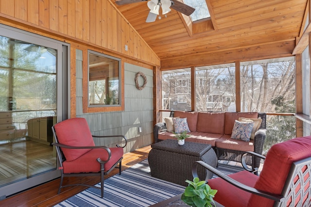 sunroom with a wealth of natural light, vaulted ceiling with skylight, wooden ceiling, and a ceiling fan