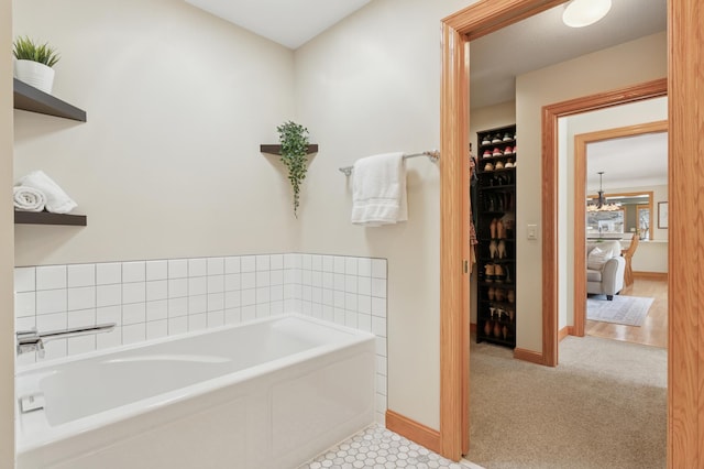 bathroom with baseboards and a garden tub