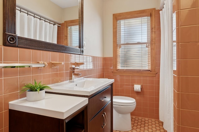 full bath featuring vanity, tile walls, curtained shower, and toilet