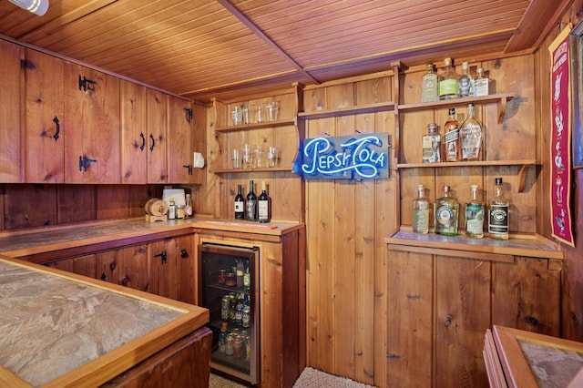 bar with wooden ceiling, beverage cooler, and a dry bar