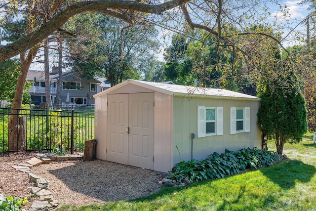 view of shed featuring fence