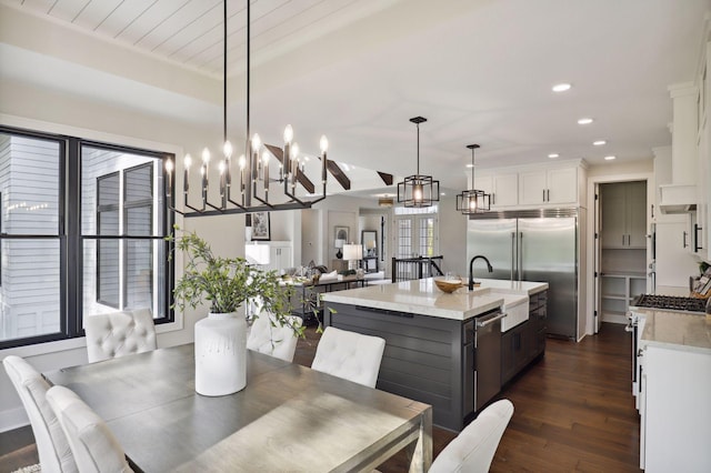 dining room with dark hardwood / wood-style flooring, a healthy amount of sunlight, and sink