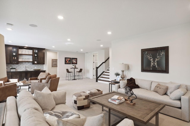 carpeted living room featuring bar area