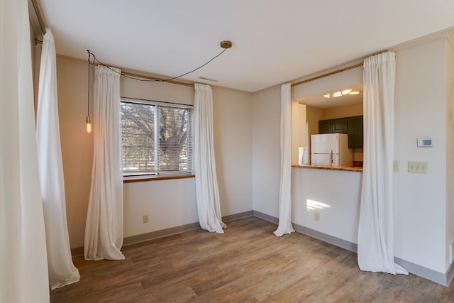 unfurnished room featuring hardwood / wood-style flooring