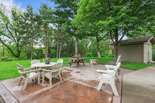 19018 Troy St NW, Elk River, MN 55330 - view of patio / terrace with outdoor dining area, a storage shed, and view of wooded area