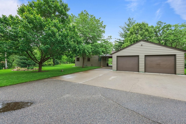 19018 Troy St NW, Elk River, MN 55330 - view of front of house featuring an outdoor structure, a garage, and a front lawn