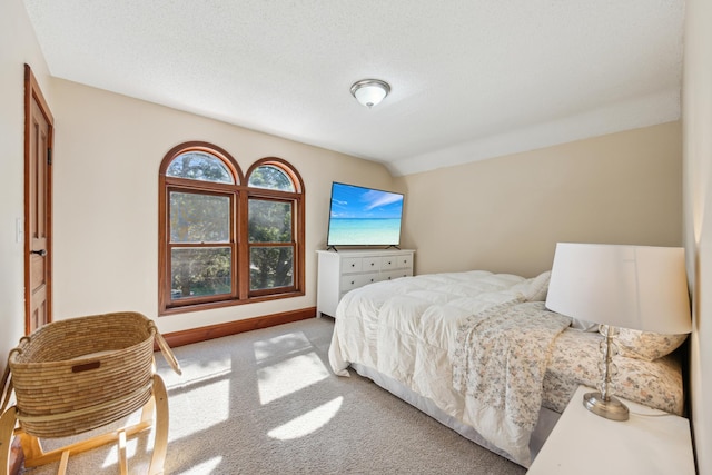 carpeted bedroom featuring lofted ceiling