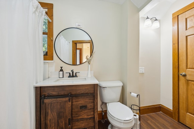 bathroom featuring hardwood / wood-style flooring, vanity, and toilet