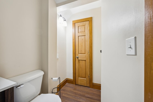 bathroom with hardwood / wood-style floors, vanity, and toilet