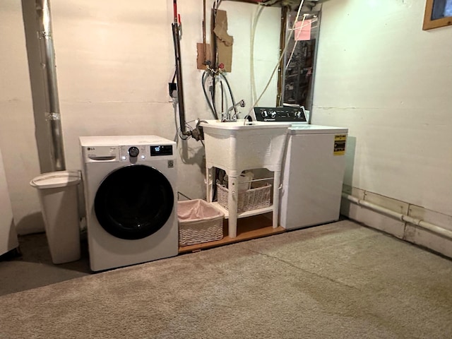 laundry room featuring independent washer and dryer, carpet floors, and sink