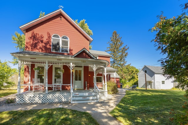 view of front facade with a front yard and covered porch