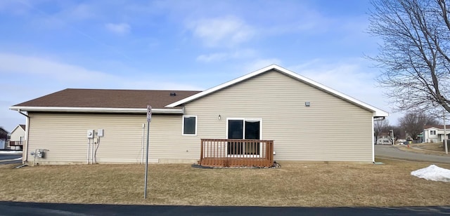 rear view of property featuring a yard