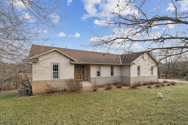 ranch-style home with cooling unit and a front yard