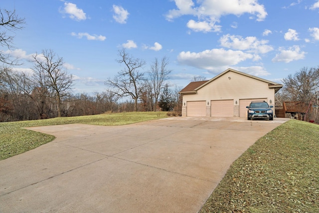 view of side of home featuring a yard and a garage