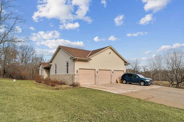 view of side of property featuring a yard and a garage