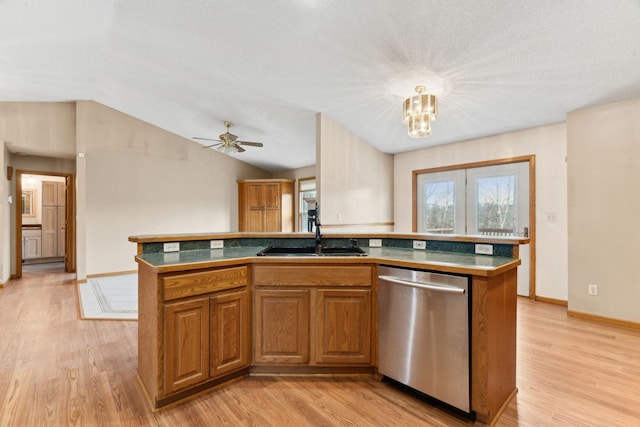 kitchen with light wood-type flooring, a center island with sink, stainless steel dishwasher, and sink