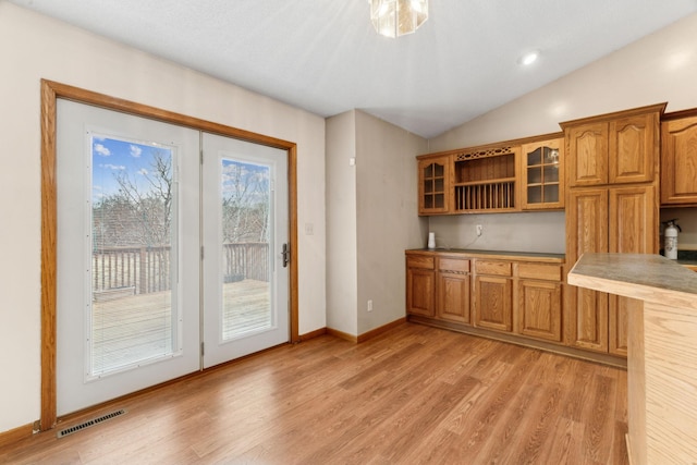 kitchen featuring lofted ceiling and light wood-type flooring