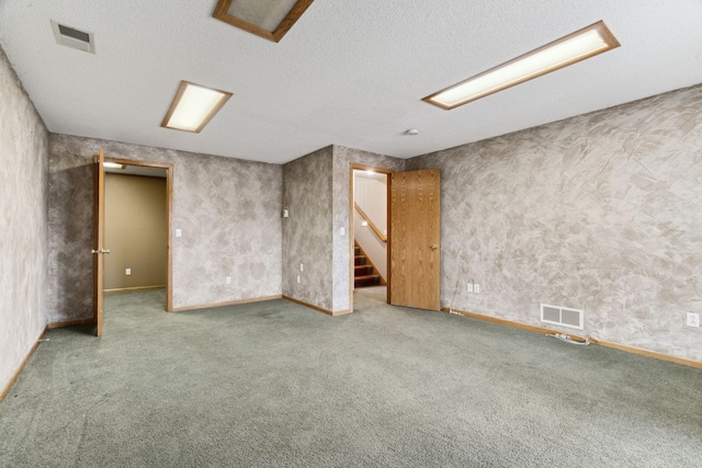 basement featuring carpet and a textured ceiling