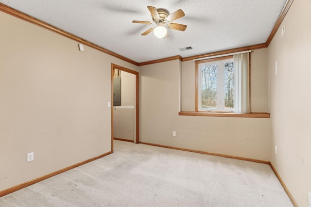 carpeted empty room featuring a textured ceiling, ceiling fan, crown molding, and electric panel