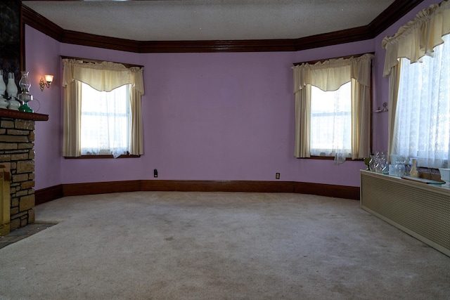 unfurnished room featuring carpet floors, plenty of natural light, and ornamental molding