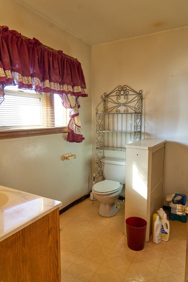 bathroom featuring baseboards, toilet, and tile patterned floors