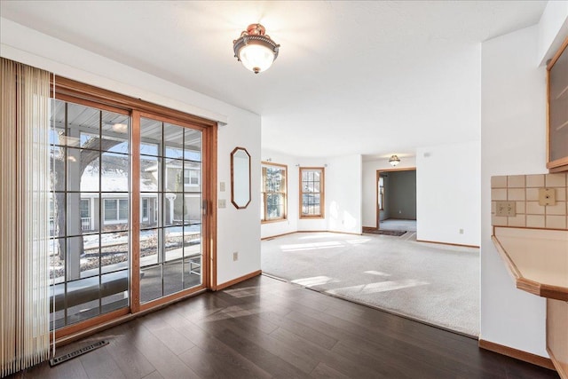 doorway with dark hardwood / wood-style floors