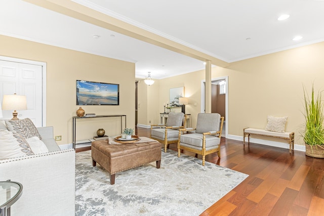 living room with wood-type flooring and crown molding