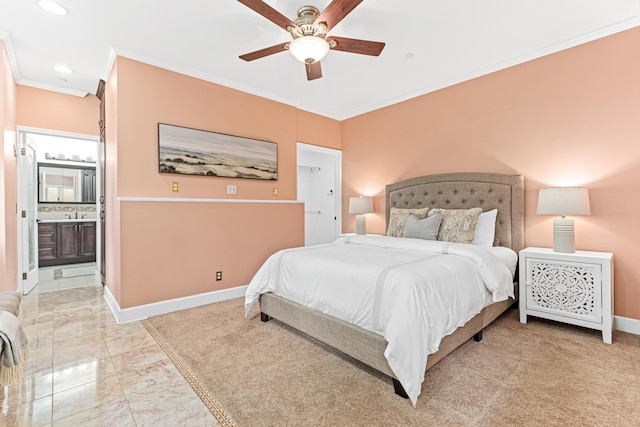 bedroom featuring ceiling fan, ornamental molding, and ensuite bath