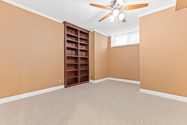 empty room with ceiling fan, carpet floors, and ornamental molding