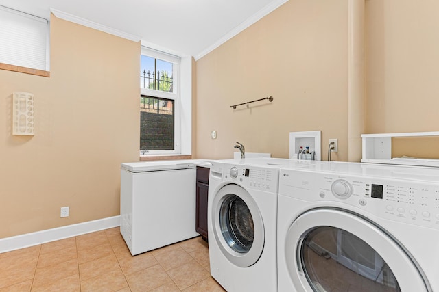 laundry room featuring light tile patterned flooring, cabinets, ornamental molding, and washing machine and clothes dryer