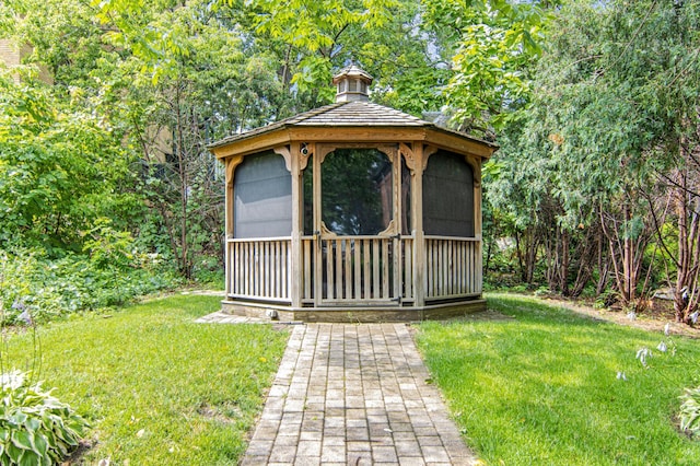 view of outdoor structure with a gazebo and a yard