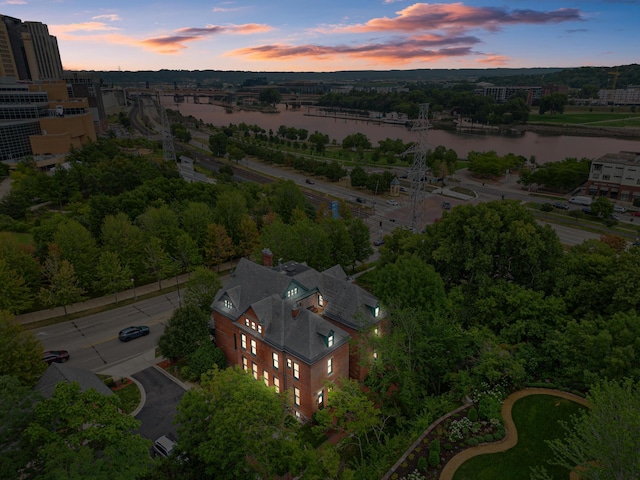 aerial view at dusk with a water view