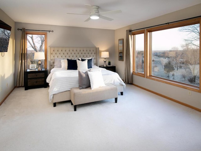 bedroom featuring light colored carpet and ceiling fan