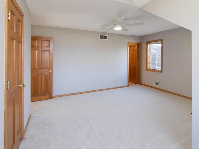 empty room featuring ceiling fan and light carpet