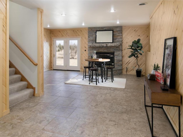 interior space with wooden walls and a stone fireplace