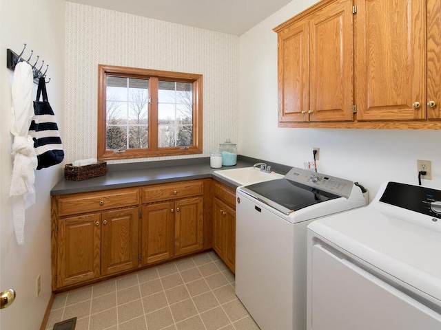 clothes washing area featuring sink, light tile patterned floors, cabinets, and independent washer and dryer