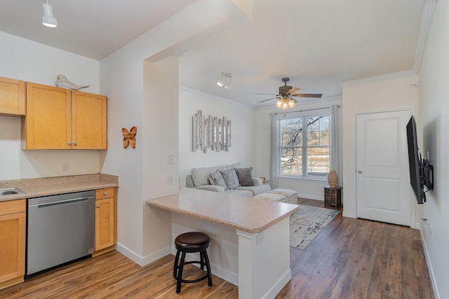 kitchen with a kitchen bar, kitchen peninsula, ceiling fan, hardwood / wood-style flooring, and dishwasher