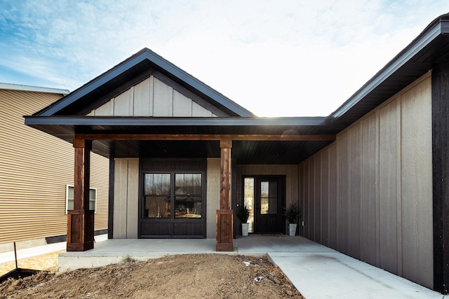 view of exterior entry with covered porch