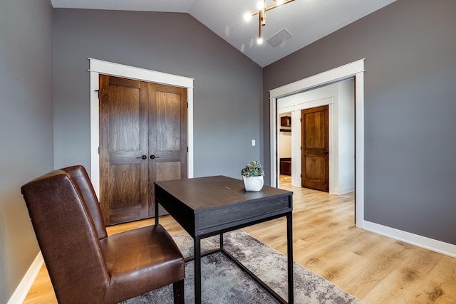 office area with vaulted ceiling, light wood-type flooring, and baseboards