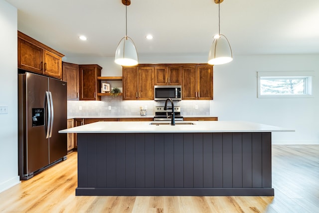 kitchen with appliances with stainless steel finishes, a sink, open shelves, light countertops, and tasteful backsplash