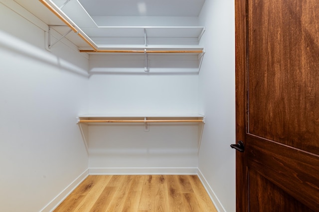 walk in closet featuring wood finished floors