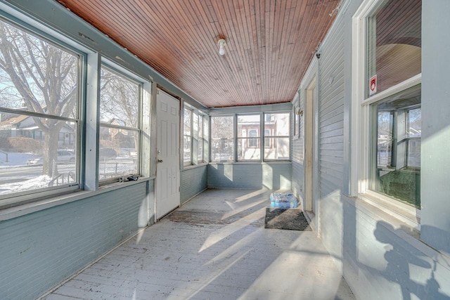 sunroom / solarium featuring wooden ceiling and a healthy amount of sunlight