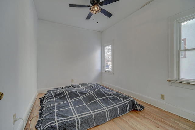 unfurnished bedroom featuring ceiling fan and hardwood / wood-style flooring