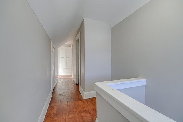 corridor featuring hardwood / wood-style floors and lofted ceiling