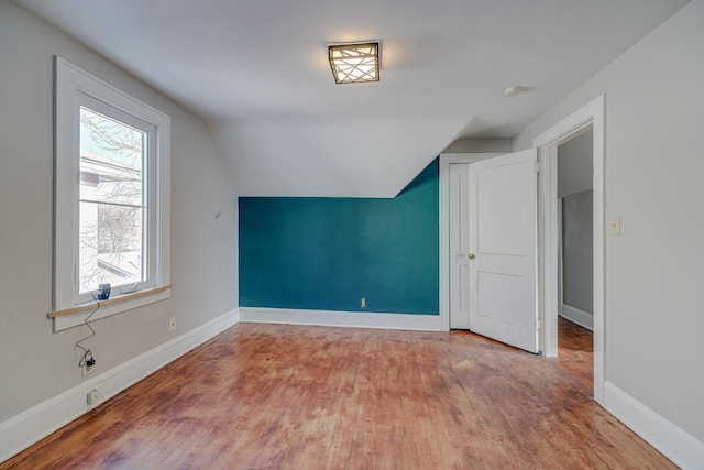 bonus room featuring lofted ceiling and wood-type flooring