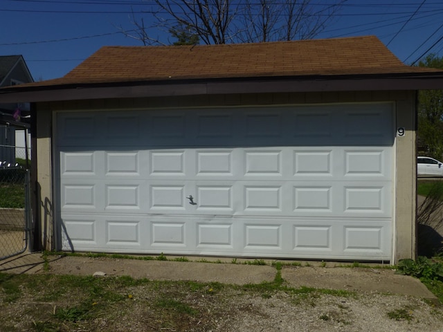detached garage featuring fence