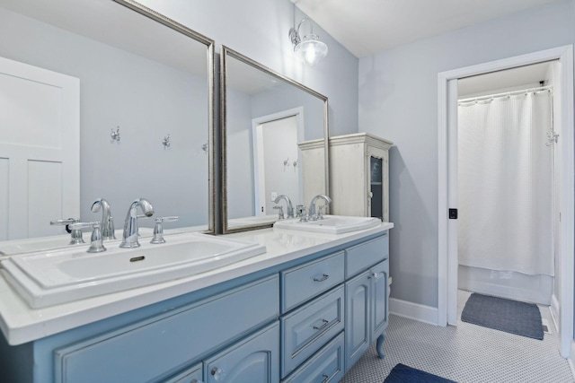 bathroom with tile patterned floors and vanity