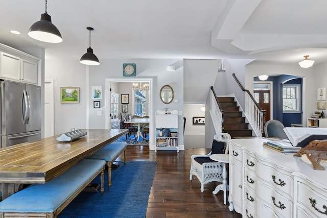 dining room with dark hardwood / wood-style flooring and a chandelier