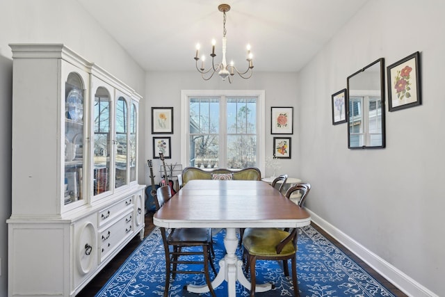 dining area featuring an inviting chandelier and dark hardwood / wood-style flooring